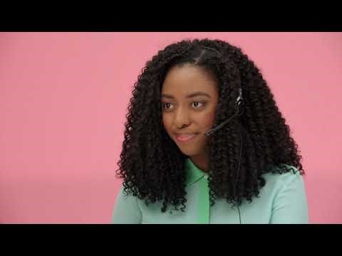 Young Black woman wearing headset and turquoise blouse on pink background - Explainer Video Thumbnail of Virtual Receptionists company Ruby