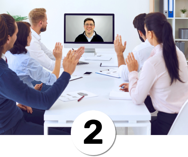 2-employees-in-meeting-looking-to-remote-trainer-on-screen